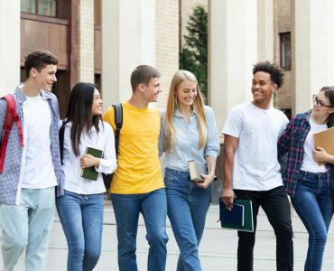 Education concept. Classmates walking in college campus